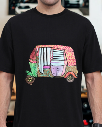Black t-shirt with a colorful graphic of a vehicle on a blurred indoor background